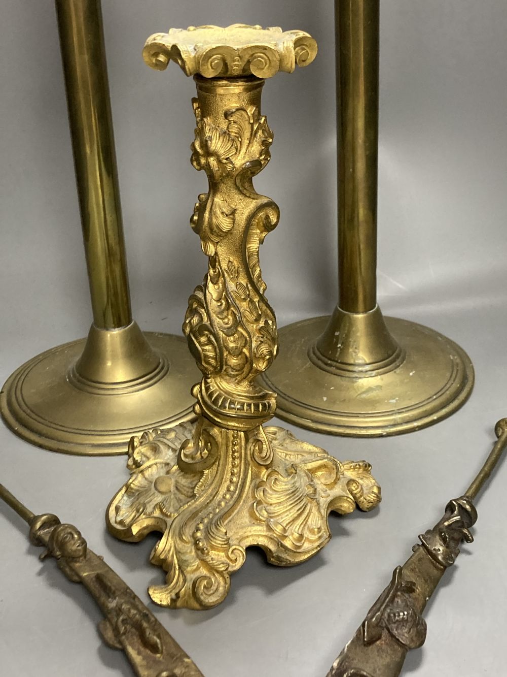 An 18th century French ormolu candlestick, 25cm, a pair of 19th century tubular brass ejector candlesticks, 46cm and two Chinese brass